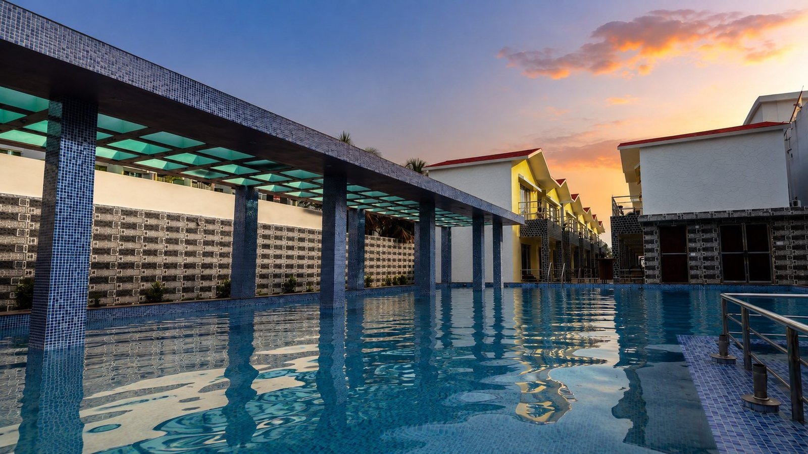 Sunset poolside view at Royal Villa Resorts Mandarmani